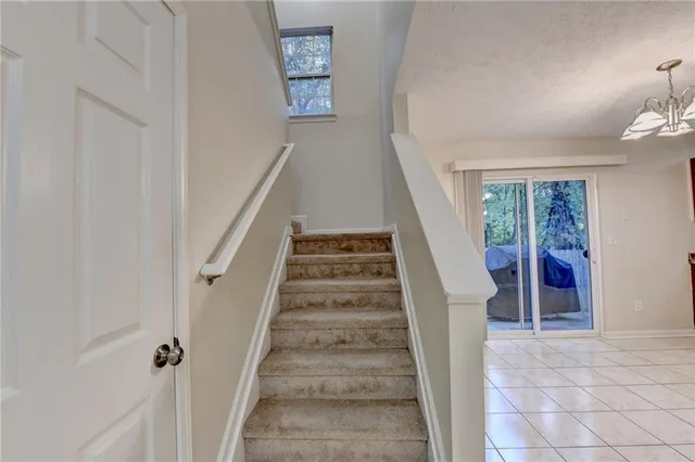 a view of staircase with white walls and windows
