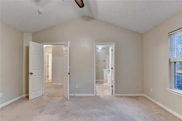 an empty room with windows and closet