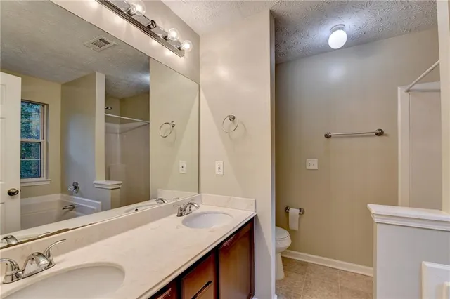 a bathroom with a sink double vanity granite and a mirror
