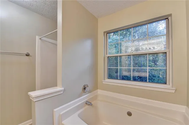 a bathroom with a tub and a shower