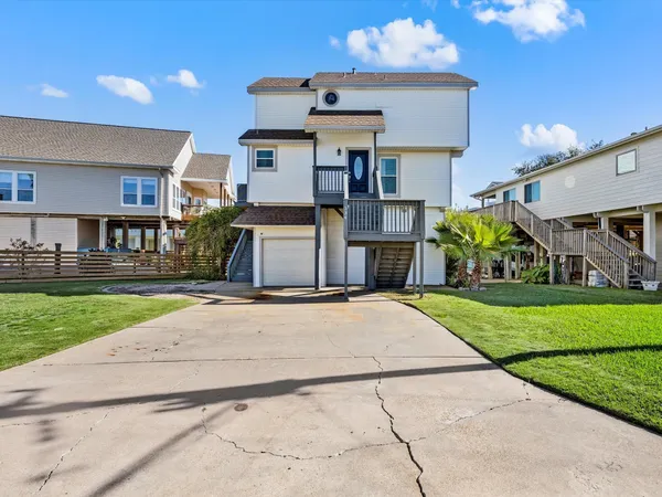 a front view of a house with a yard and a street