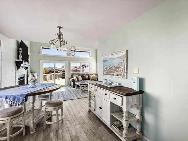 a living room with furniture and a kitchen view