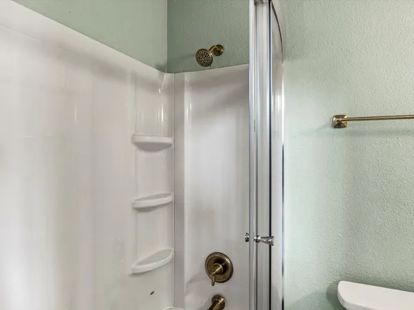a bathroom with a shower and a toilet