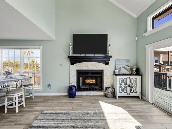 a living room with furniture a flat screen tv and a fireplace