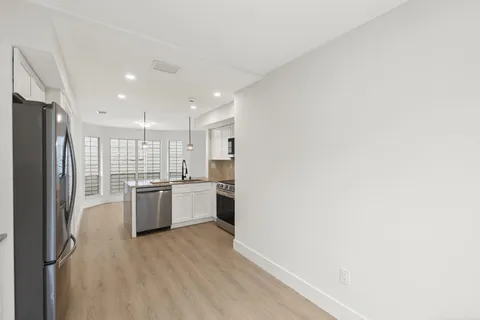 a kitchen with a refrigerator and a sink
