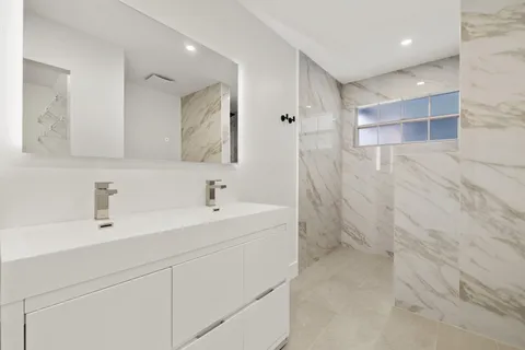 a bathroom with a sink a toilet and a mirror