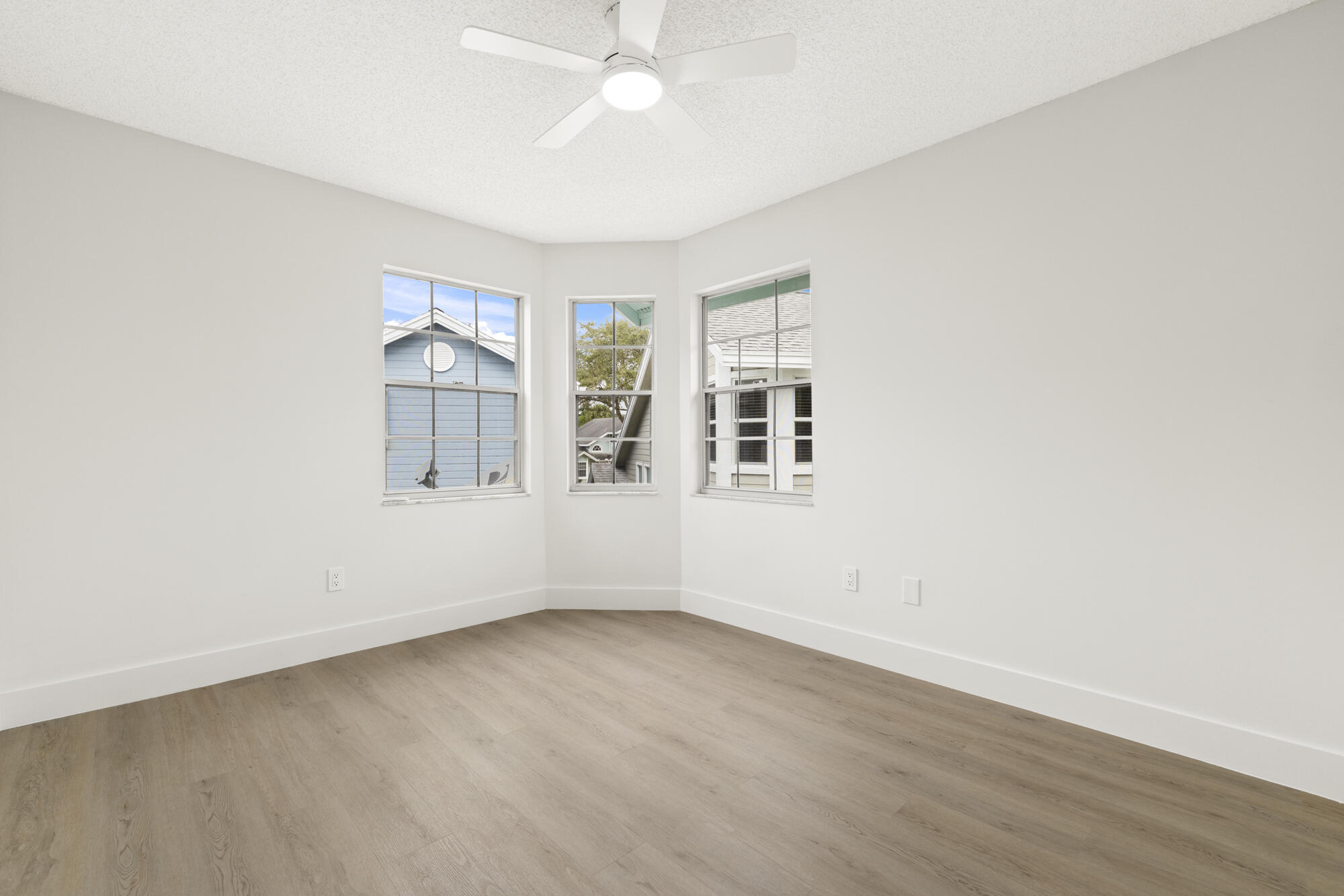 5115 Coronado Ridge Boca Raton, FL 33431 - Photo 17 of 31 an empty room with wooden floor and windows