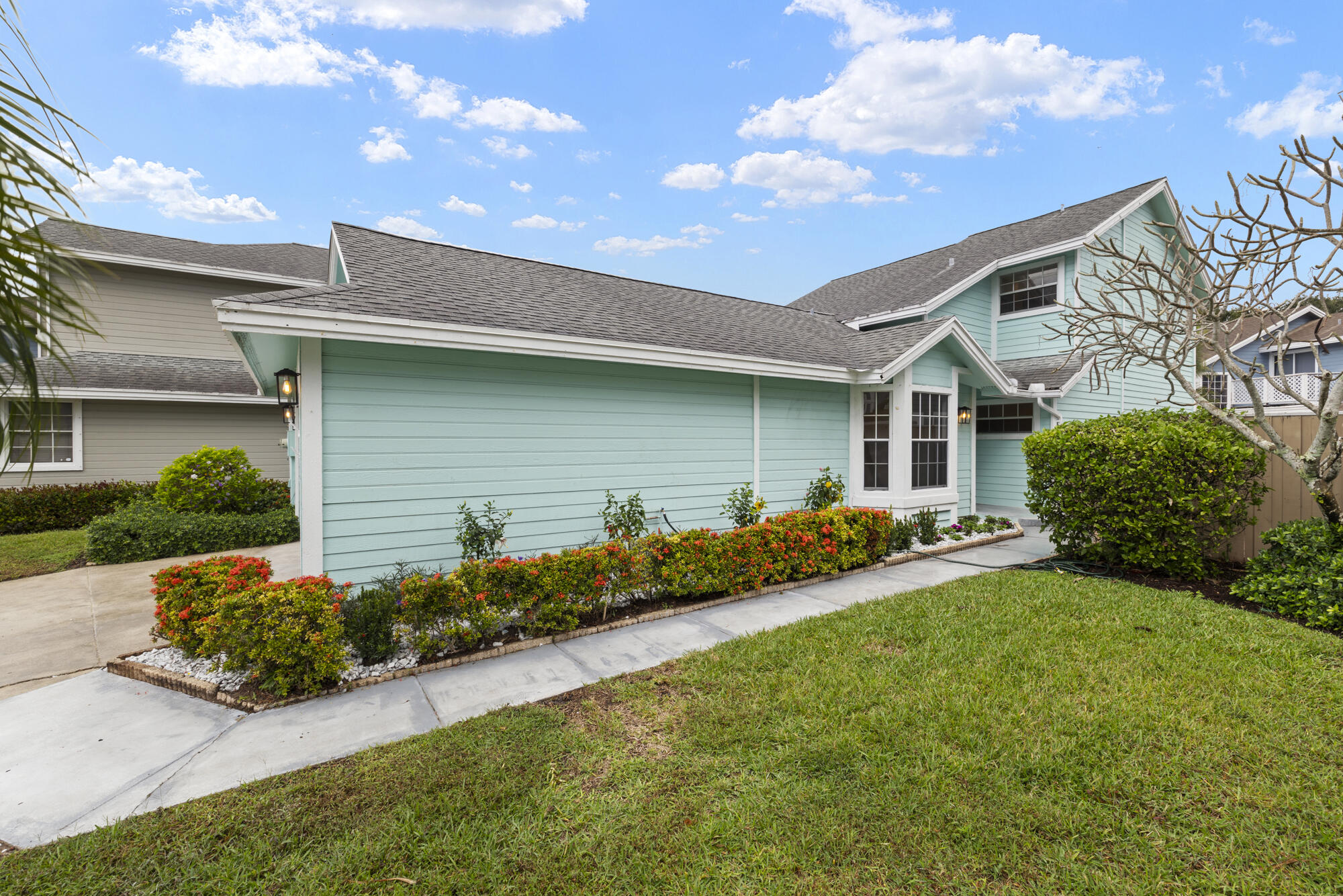 5115 Coronado Ridge Boca Raton, FL 33431 - Photo 2 of 31 a front view of a house with a yard and garage