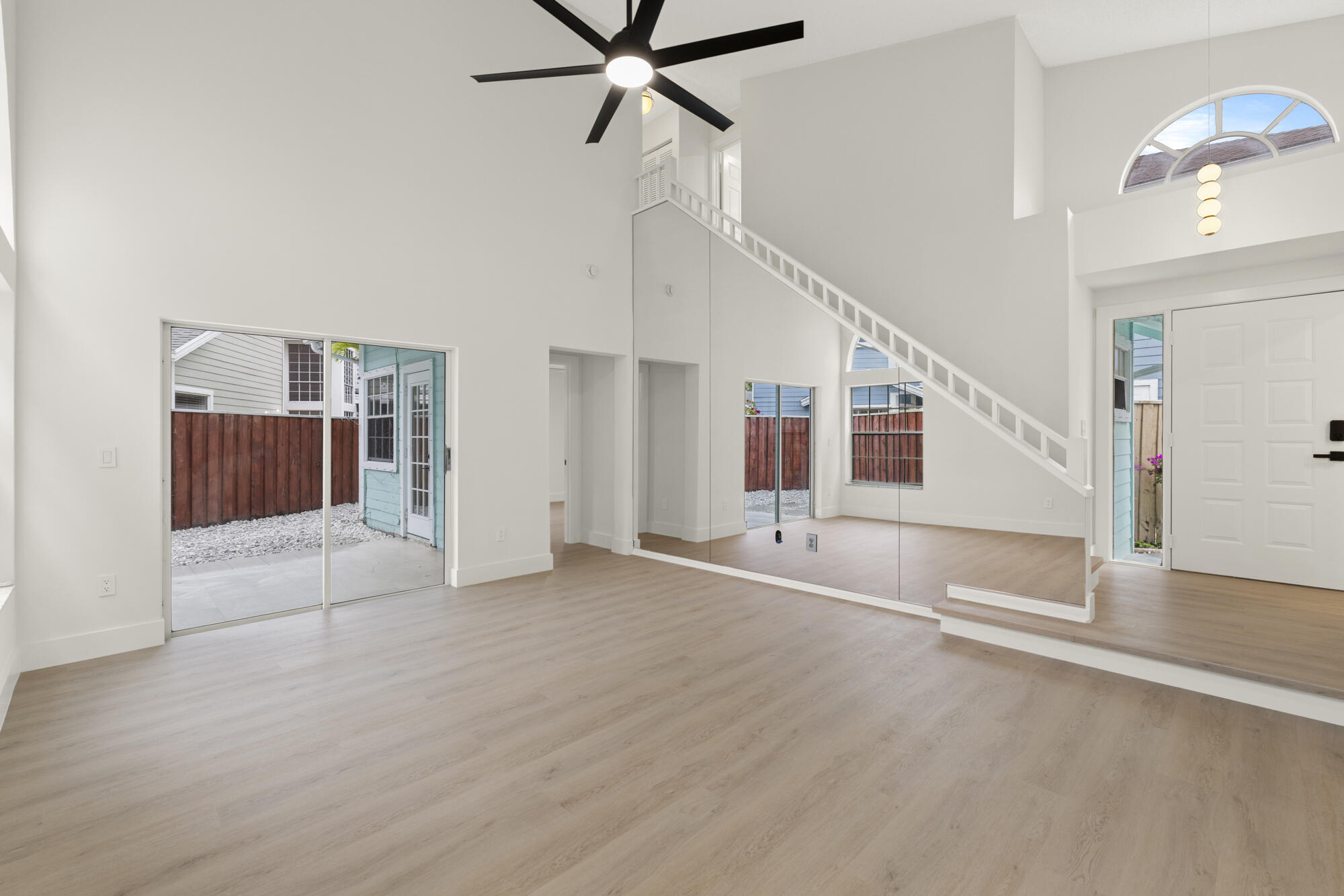 5115 Coronado Ridge Boca Raton, FL 33431 - Photo 4 of 31 a view of a livingroom with wooden floor and stairs