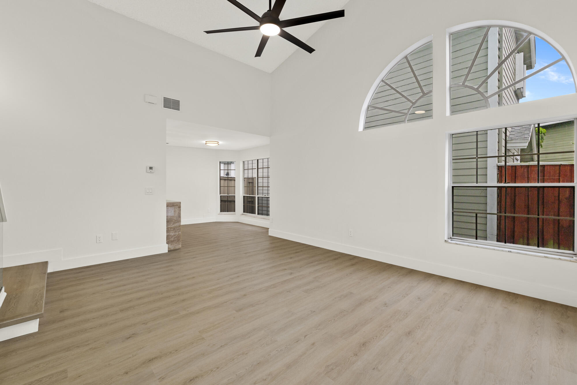 5115 Coronado Ridge Boca Raton, FL 33431 - Photo 5 of 31 wooden floor in an empty room with a window