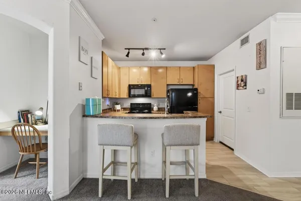 a stove top oven sitting inside of a kitchen