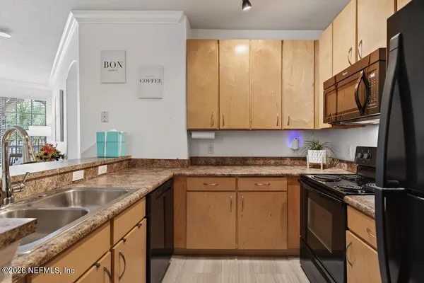 a kitchen with granite countertop a sink and a stove