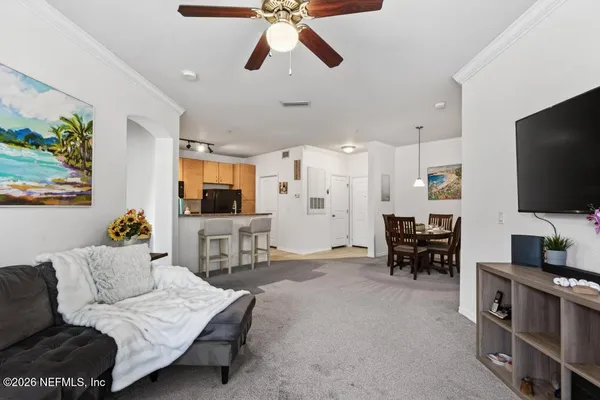 a bedroom with a bed flat screen tv and window