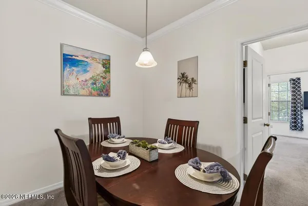 a dining room with furniture a rug and wooden floor