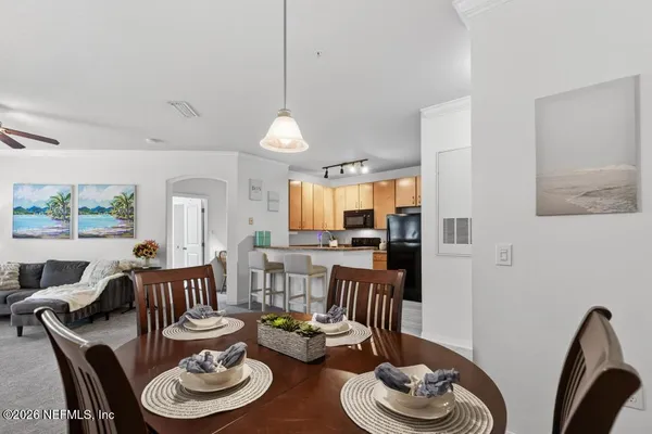 a kitchen that has a refrigerator and a stove top oven