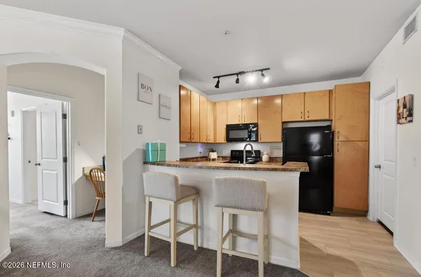 a kitchen with stainless steel appliances granite countertop a refrigerator and a stove top oven