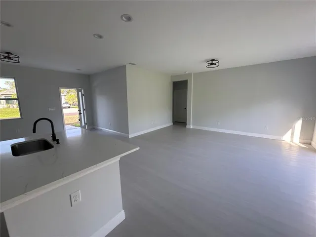 a view of a kitchen with a sink and a window