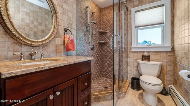 a bathroom with a granite countertop toilet a sink and a mirror