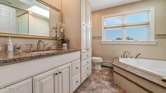 a bathroom with a double vanity sink and a window