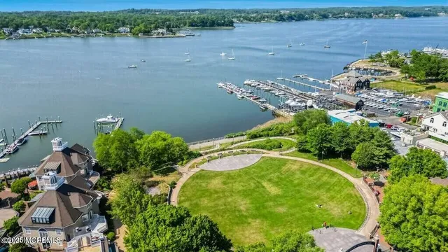 an aerial view of a house with a yard and lake view