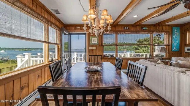 a view of a dining room with furniture a chandelier and wooden floor