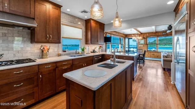 a kitchen with a sink a stove and a wooden floors