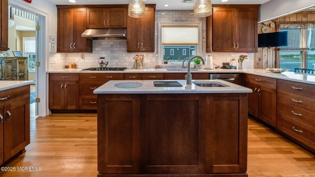 a kitchen with wooden cabinets a sink and a stove
