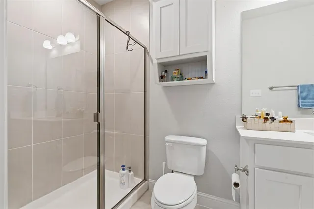 a white toilet sitting next to a bathroom sink