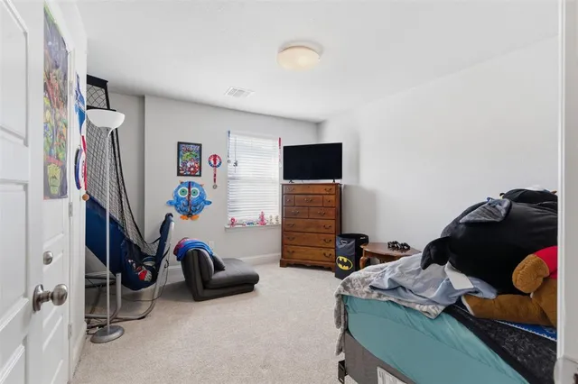 a bedroom with furniture and a gym equipment