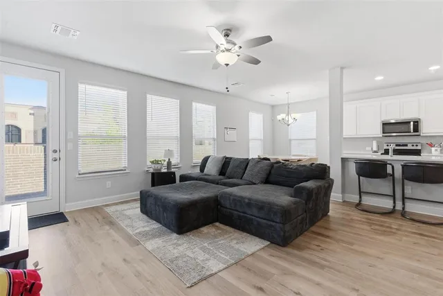 a living room with furniture and a large window