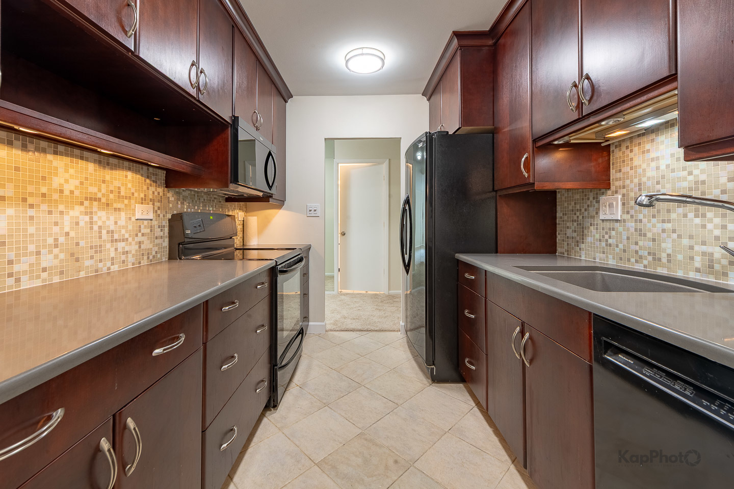 120 Lakeview Drive, Unit 318 Bloomingdale, IL 60108 - Photo 11 of 31 a kitchen with stainless steel appliances granite countertop a sink a stove and a refrigerator