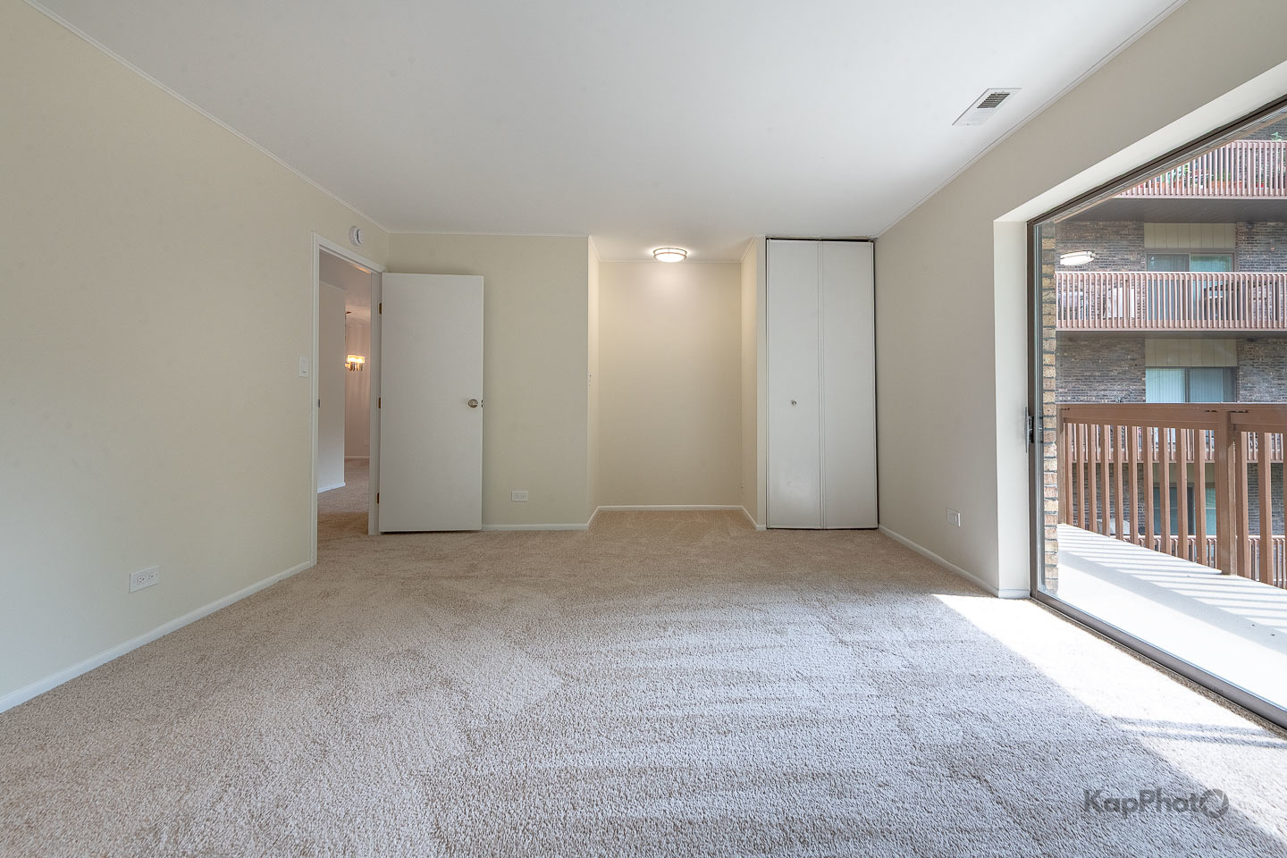 120 Lakeview Drive, Unit 318 Bloomingdale, IL 60108 - Photo 16 of 31 a view of an empty room with a sliding door