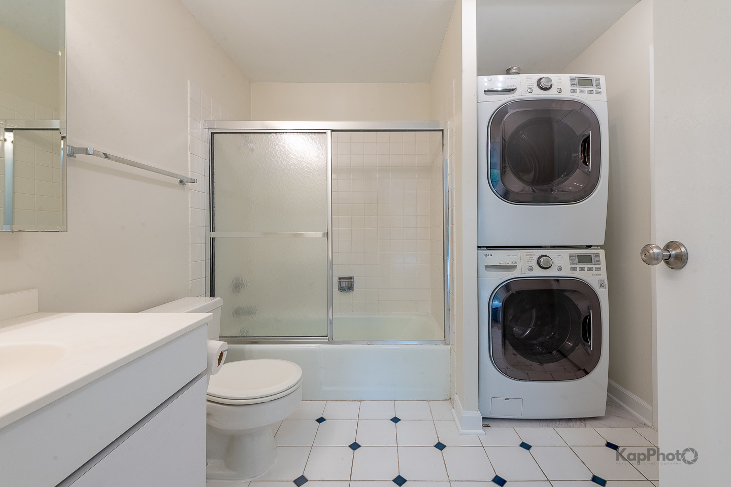 120 Lakeview Drive, Unit 318 Bloomingdale, IL 60108 - Photo 19 of 31 a bathroom with a toilet sink a washer and dryer