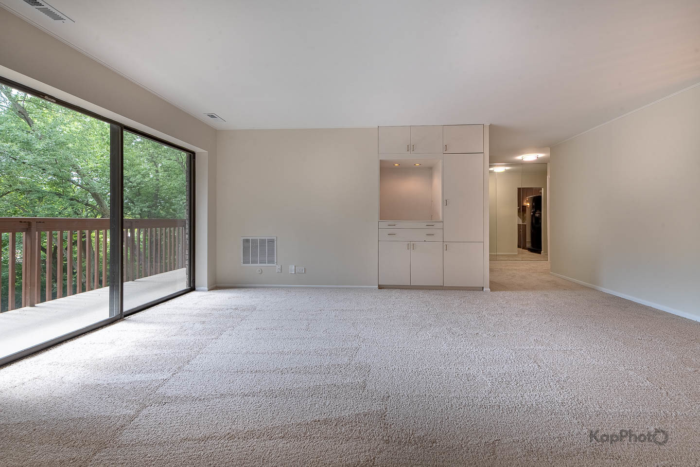 120 Lakeview Drive, Unit 318 Bloomingdale, IL 60108 - Photo 5 of 31 a view of an empty room with glass door and balcony