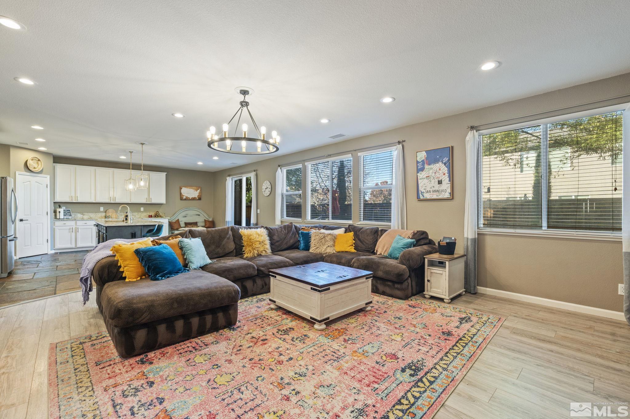 405 Teramo Court Reno, NV 89521 - Photo 17 of 40 a living room with furniture and a chandelier