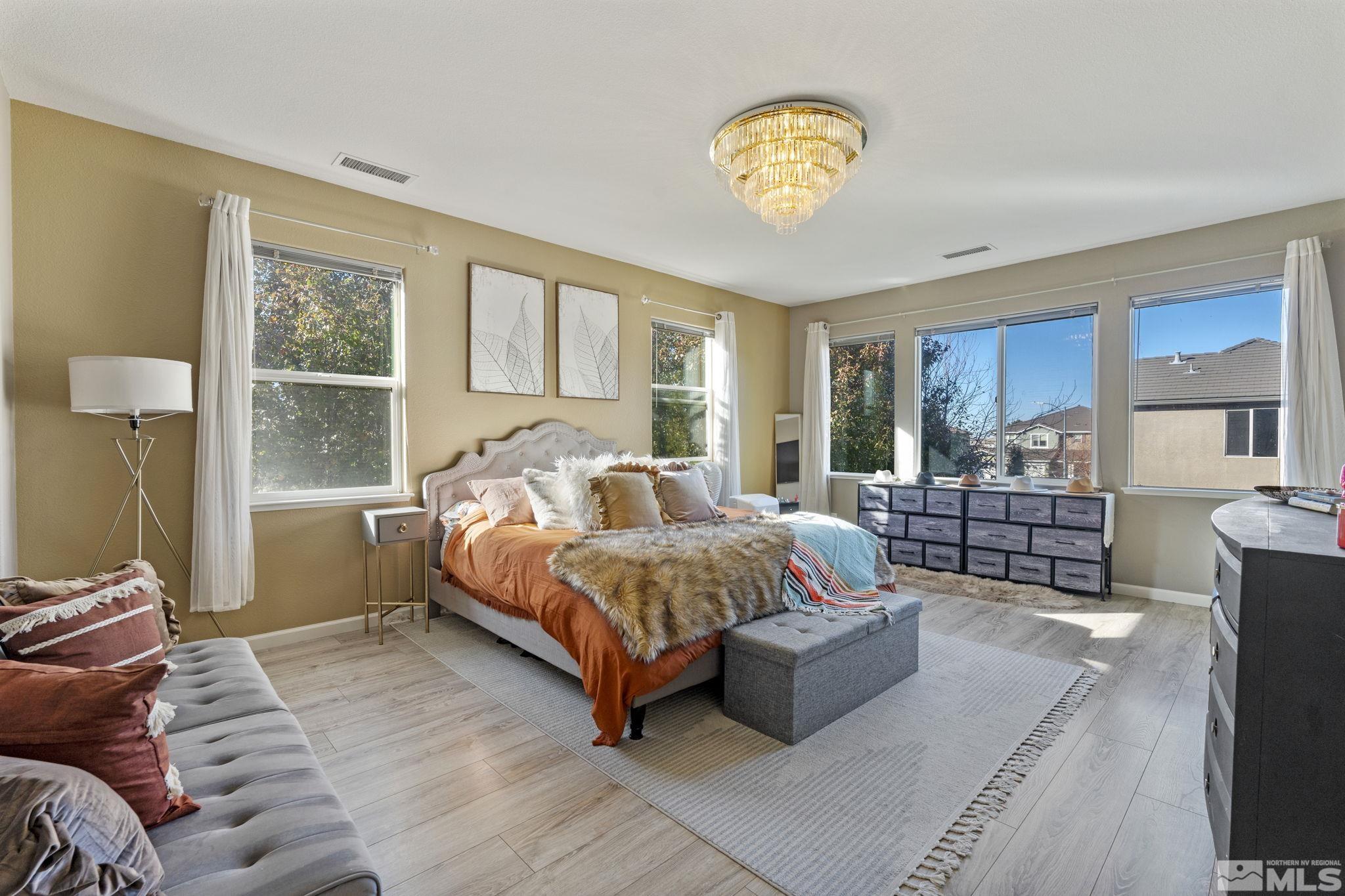 405 Teramo Court Reno, NV 89521 - Photo 18 of 40 a bedroom with a bed couch and window