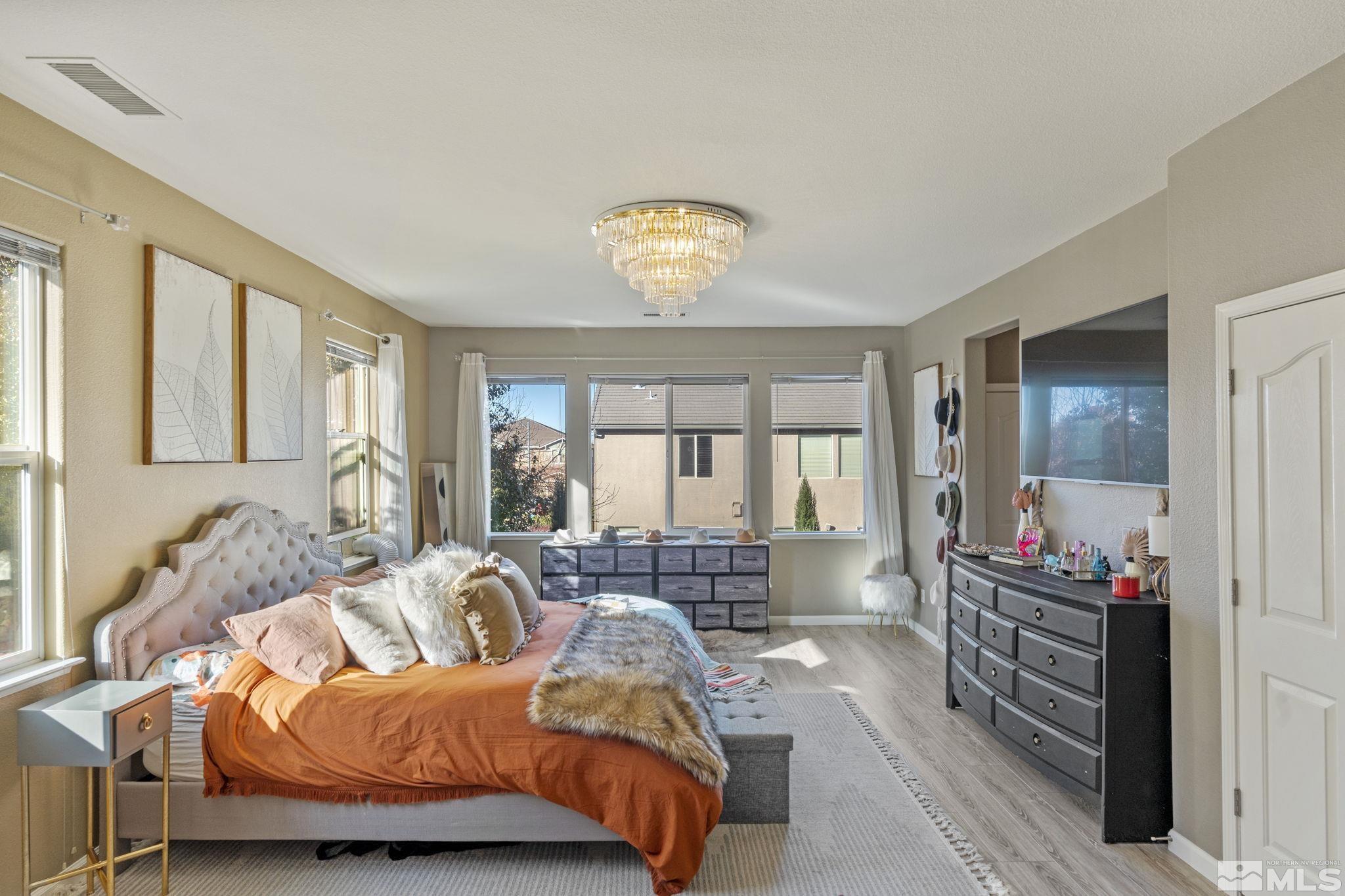 405 Teramo Court Reno, NV 89521 - Photo 19 of 40 a bedroom with a bed and wooden floor