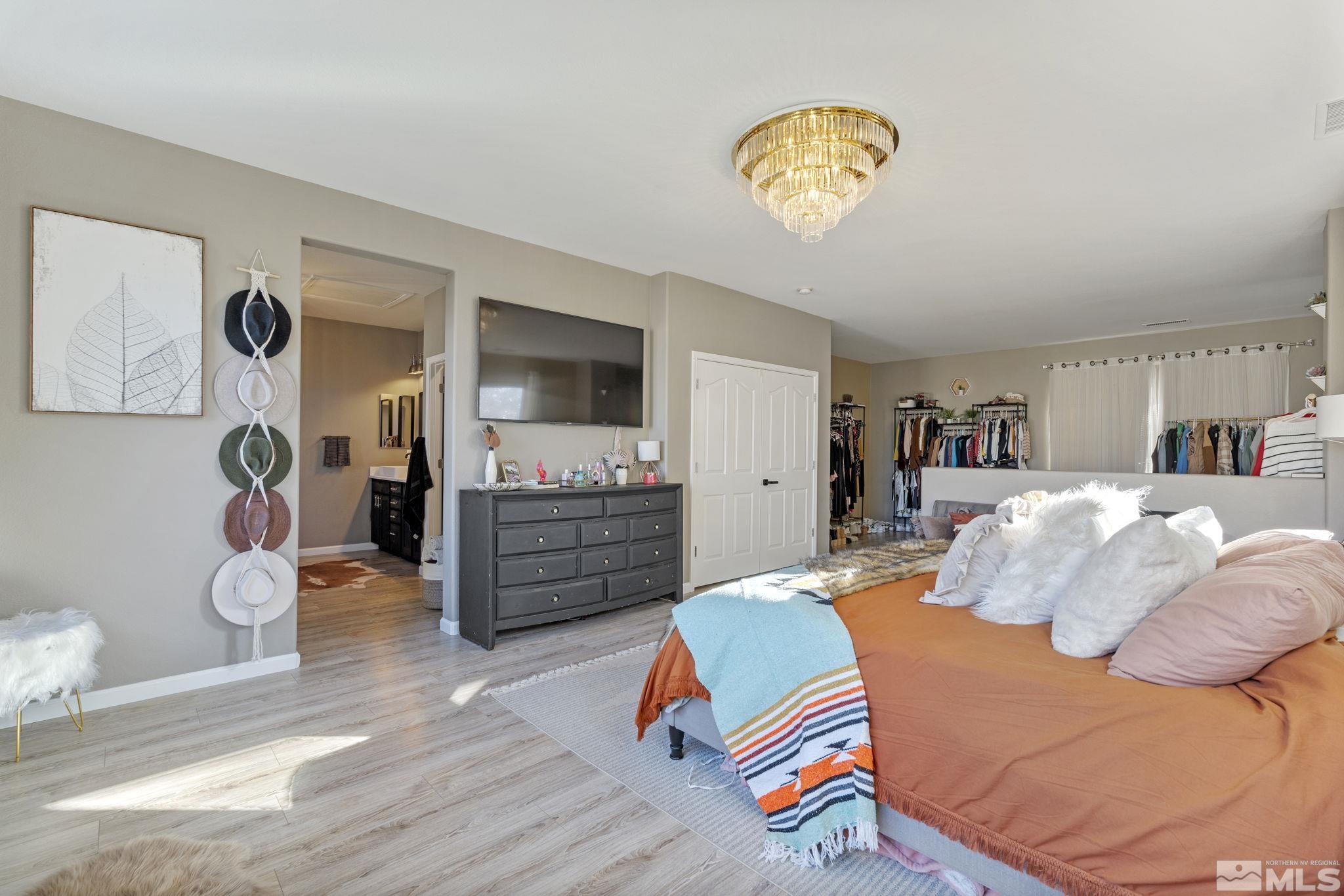 405 Teramo Court Reno, NV 89521 - Photo 20 of 40 a bedroom with a bed and wooden floor