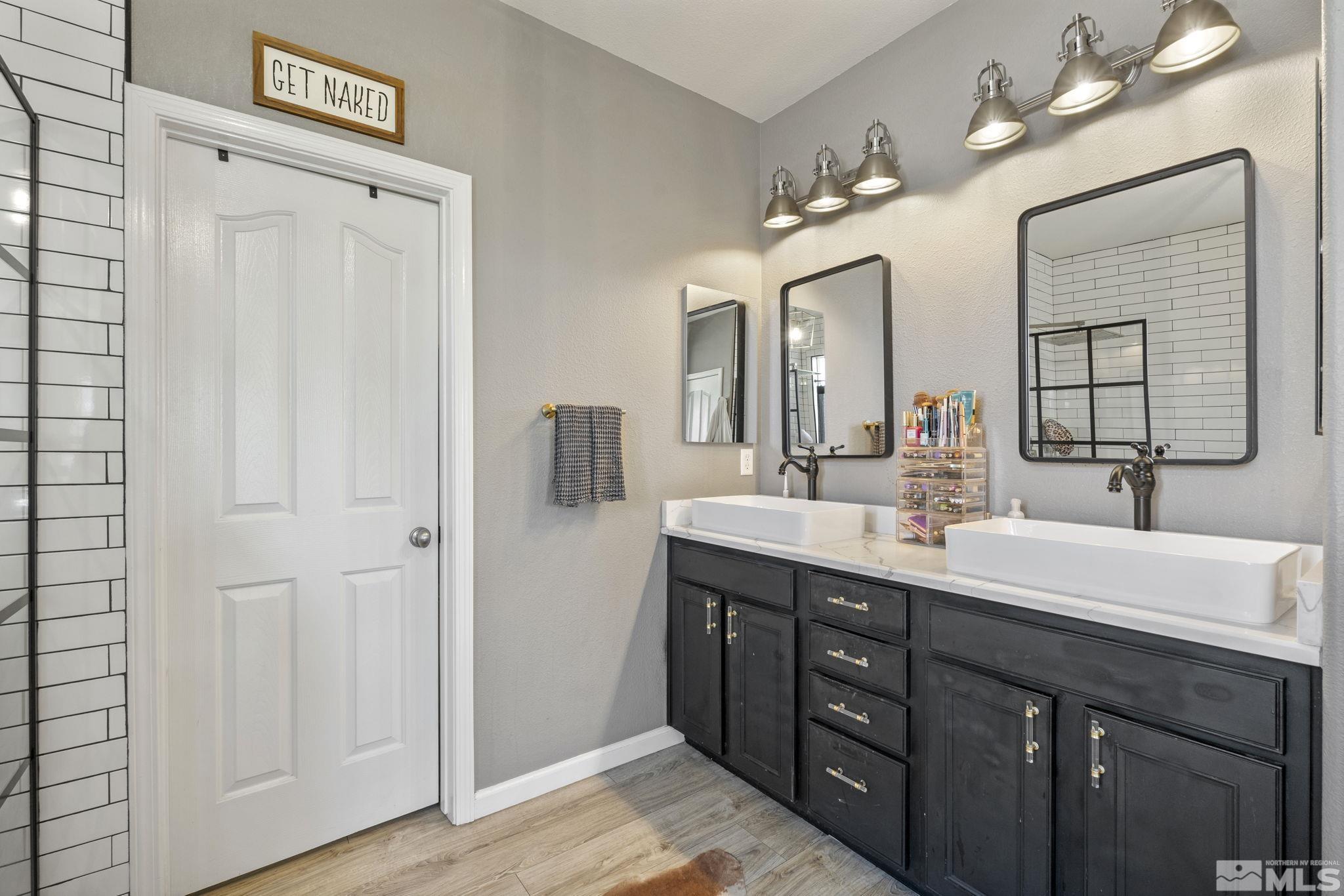 405 Teramo Court Reno, NV 89521 - Photo 22 of 40 a spacious bathroom with a double vanity sink and a mirror