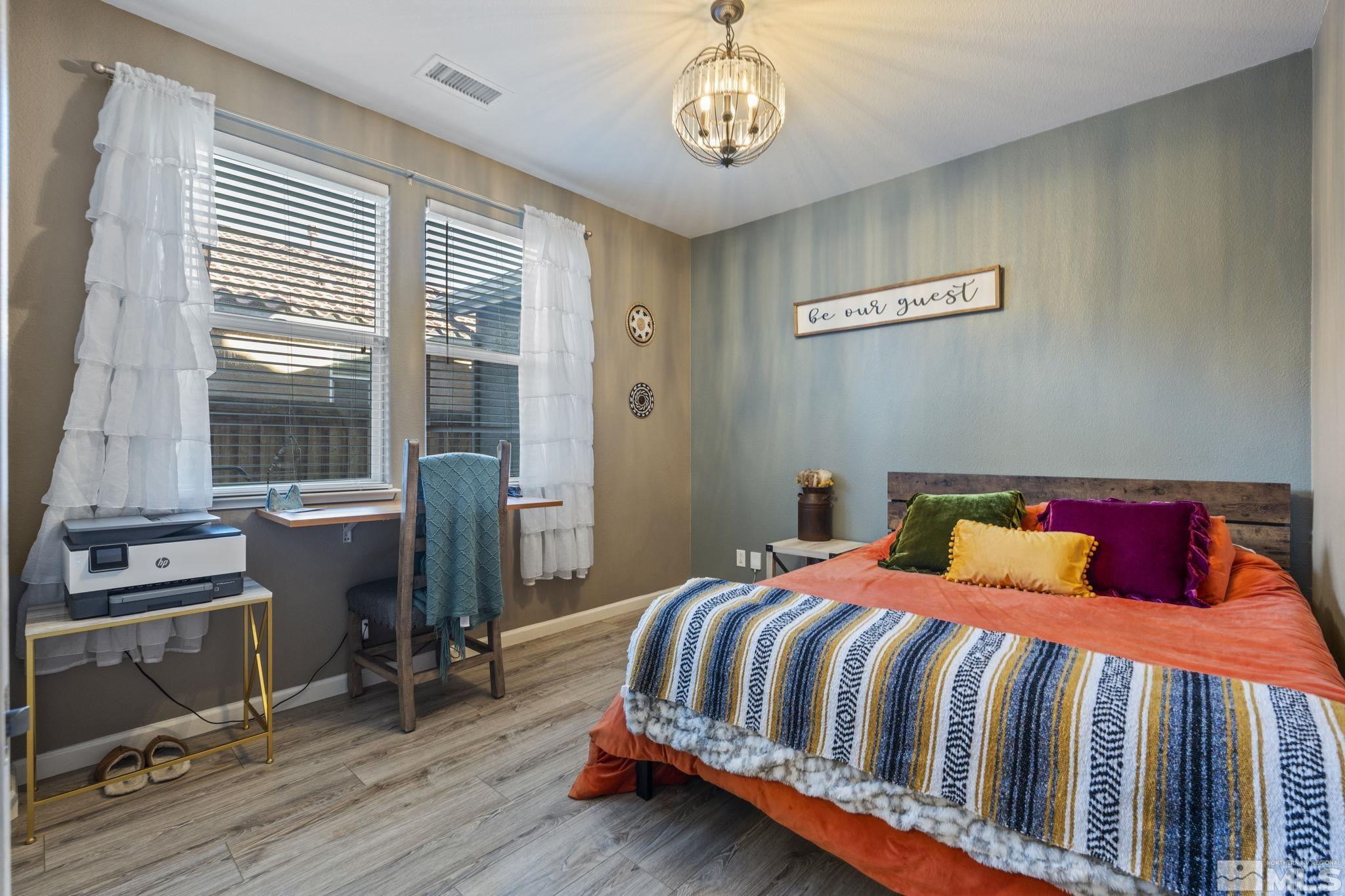 405 Teramo Court Reno, NV 89521 - Photo 28 of 40 a bedroom with a bed and a table with wooden floor