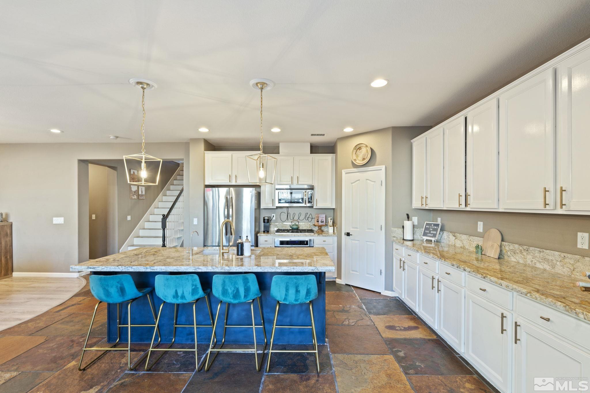 405 Teramo Court Reno, NV 89521 - Photo 8 of 40 a kitchen with a table chairs wooden floors and a view of living room