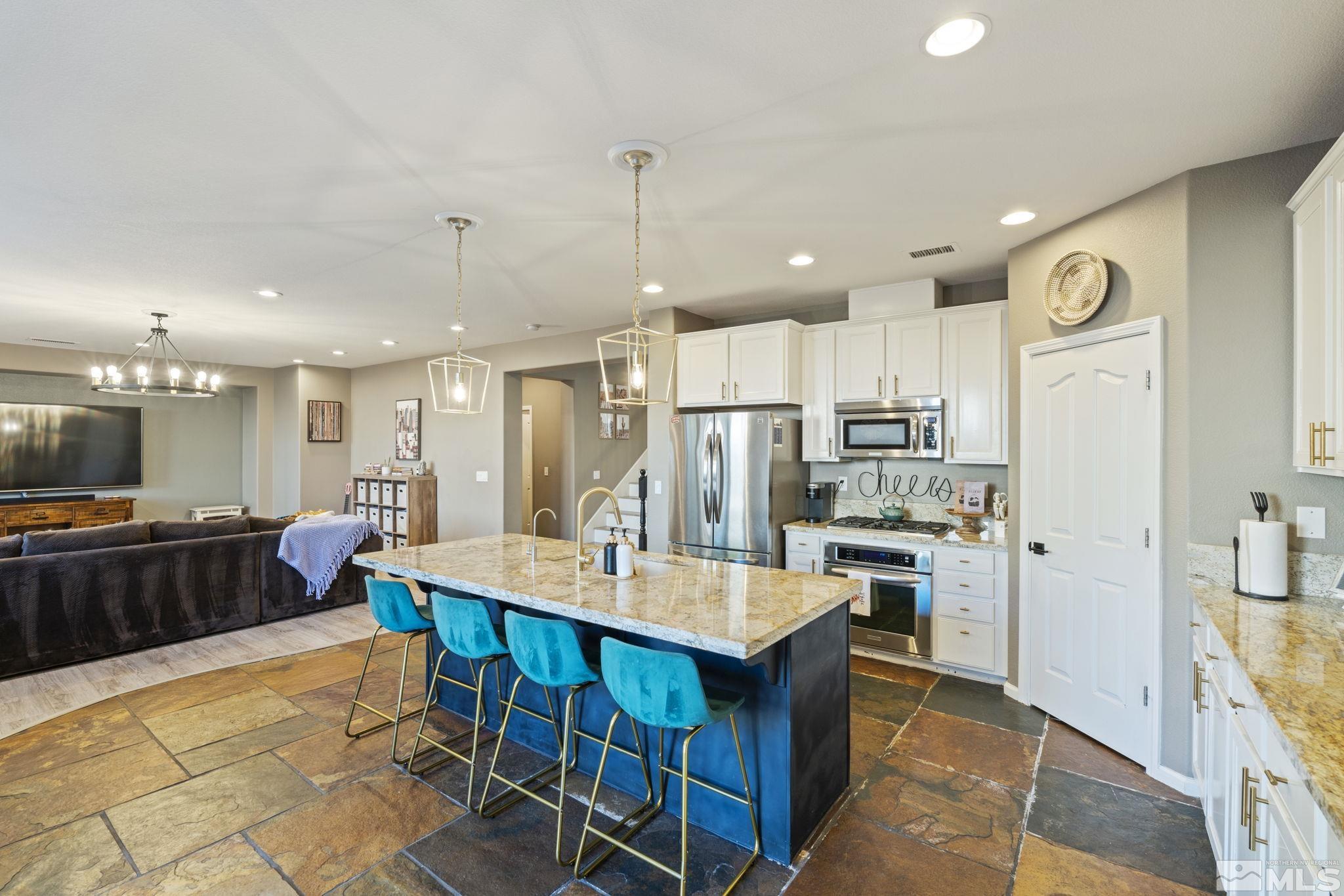 405 Teramo Court Reno, NV 89521 - Photo 10 of 40 a large kitchen with a table and chairs