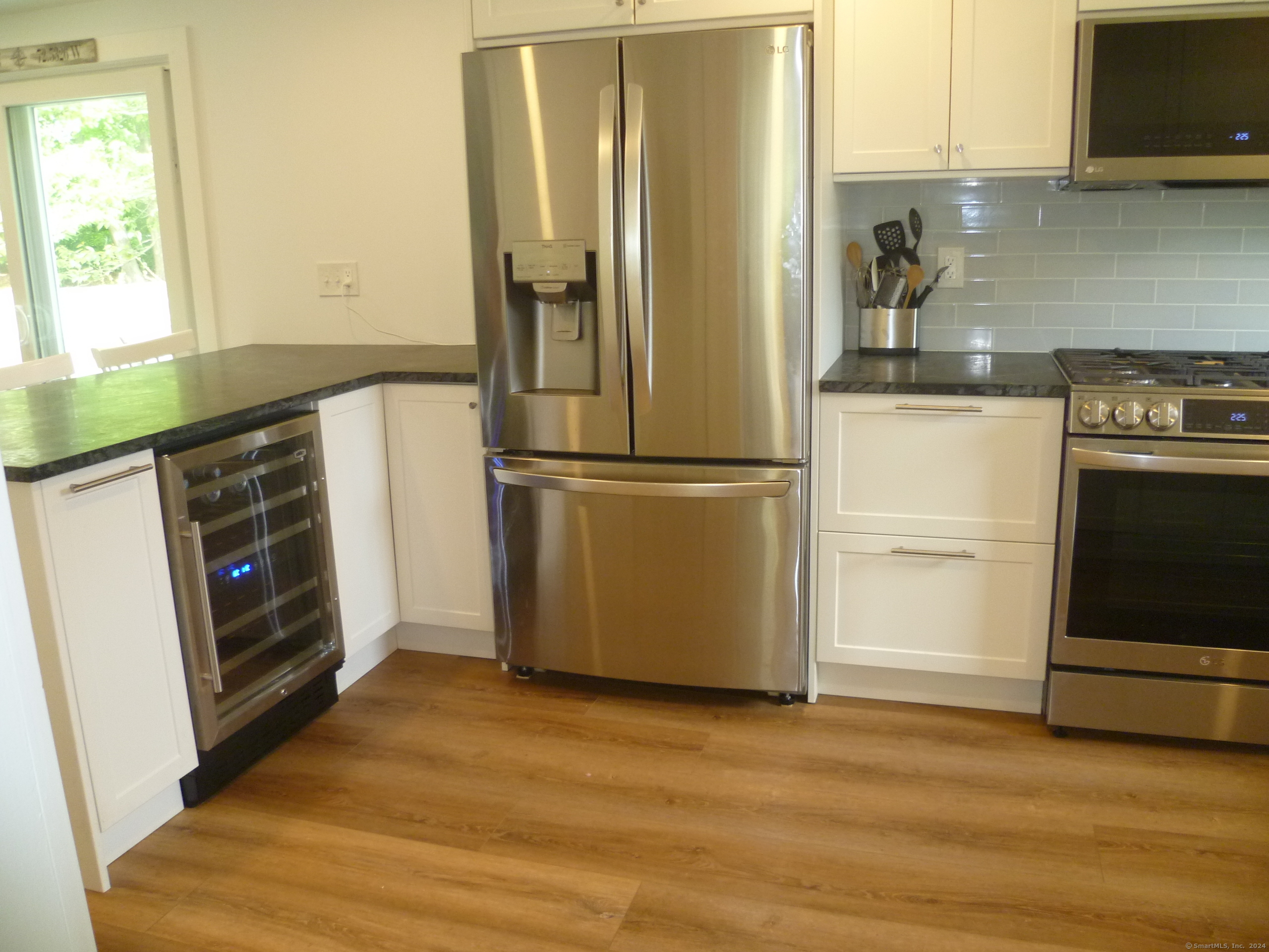 New appliances in Kitchen include a wine cooler, dishwasher, large refigerator and oven range