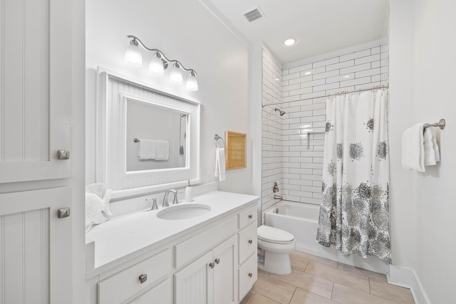 41 West Cobia Run Inlet Beach Inlet Beach, FL 32461 - Photo 17 of 32 a bathroom with a granite countertop sink toilet a large mirror a shower and a bathtub
