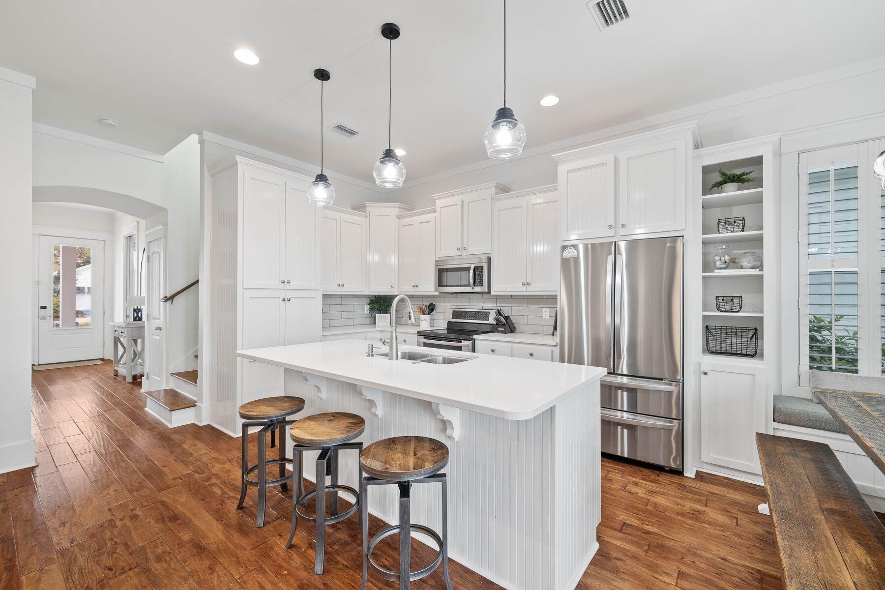 41 West Cobia Run Inlet Beach Inlet Beach, FL 32461 - Photo 7 of 32 a kitchen with stainless steel appliances a refrigerator a sink dishwasher a stove and a dining table with wooden floor