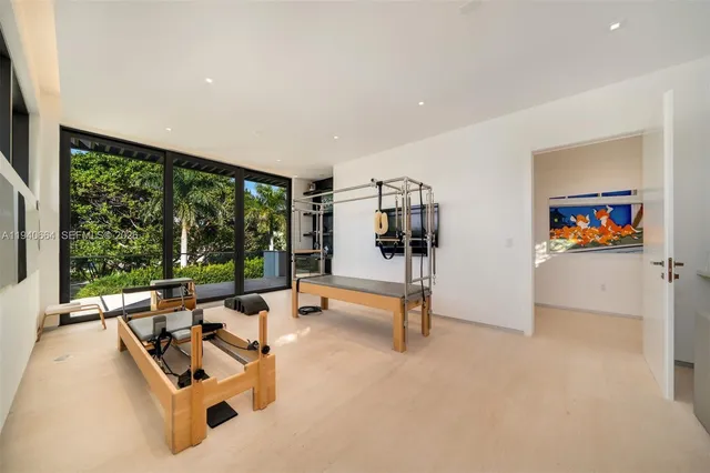 a view of a room with gym equipment and floor to ceiling window