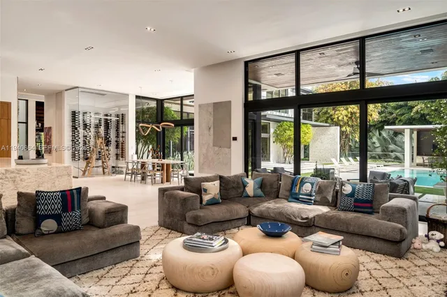 a living room with furniture and large windows