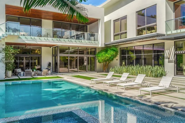 a swimming pool with outdoor seating yard and plants