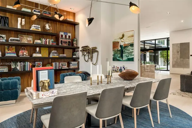 a dining room with furniture and a book shelf