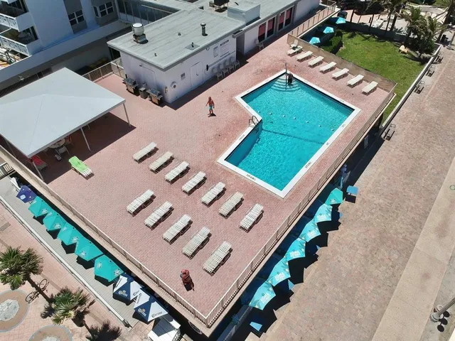 a view of a patio with a table and chairs